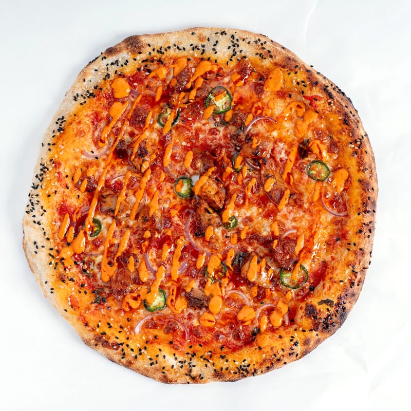 Spicy chicken pizza with jalapeño and sesame crust